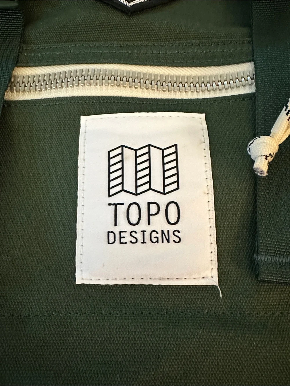 Topo Designs Mini River Green Canvas Backpack with White Zip Pocket